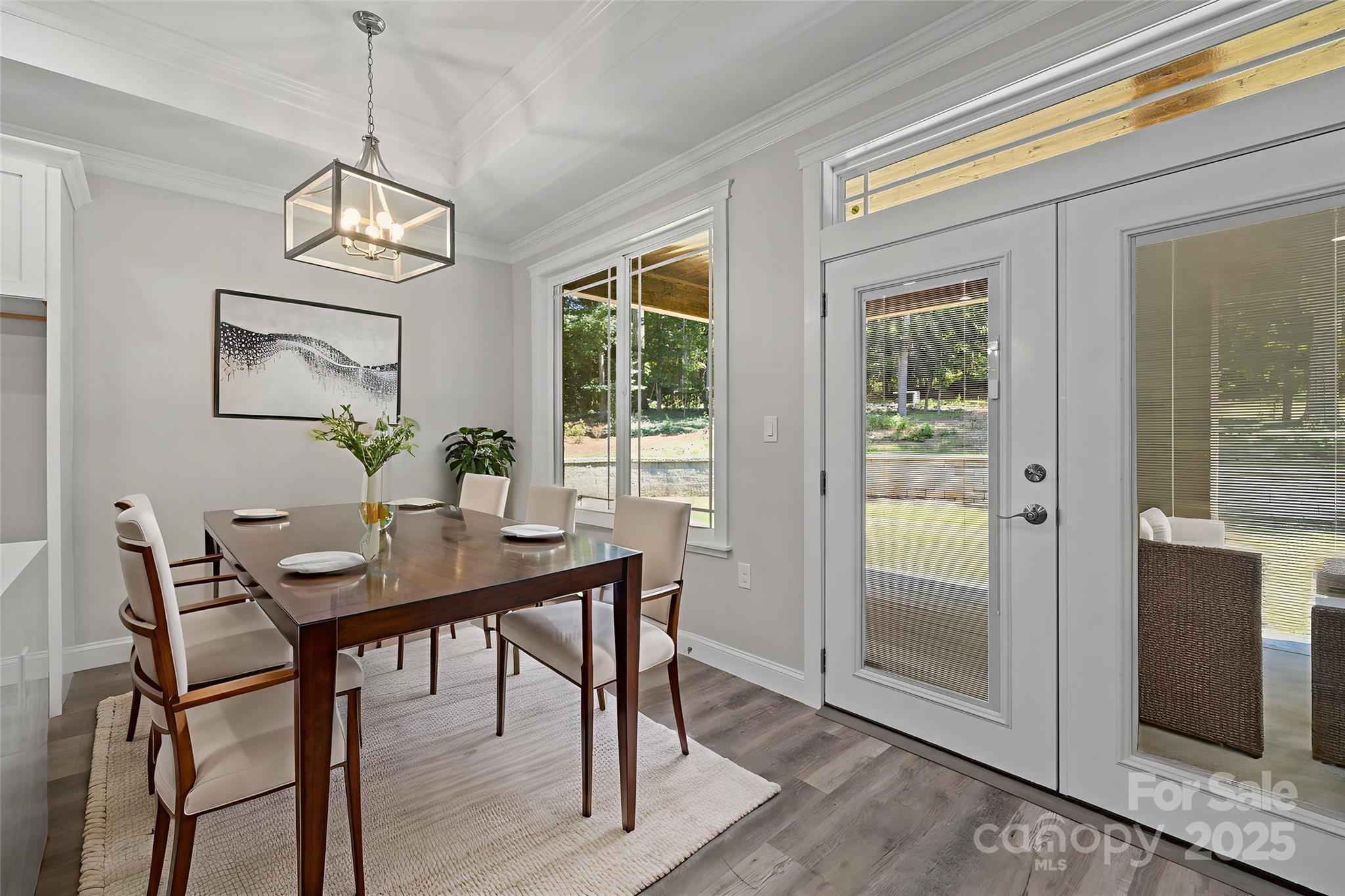 4531 Deer Run Rock Hill, SC 29732 - Photo 6 of 32 a dining room with wooden floor a glass table and chairs