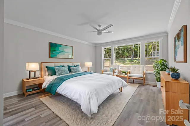 a spacious bedroom with a bed couch and a large window