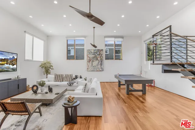 a living room with furniture a rug and a flat screen tv