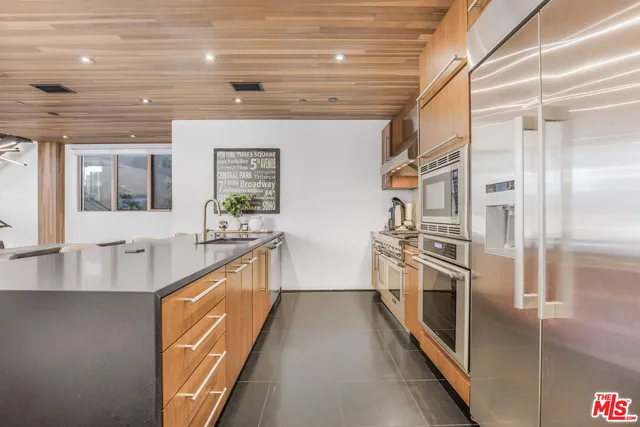 a large kitchen with stainless steel appliances granite countertop a large stove top oven