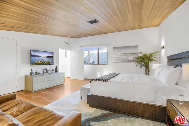 a bedroom with a bed and a couch