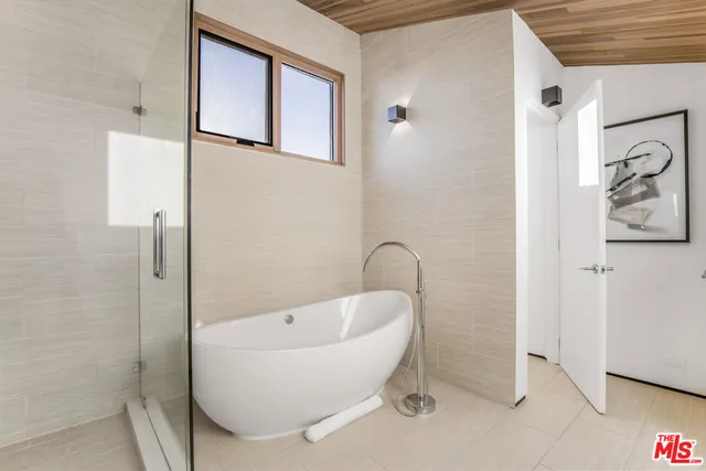 a white bath tub sitting next to a bathroom sink