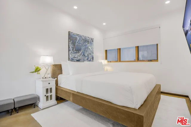 a bed room with a bed and a chair