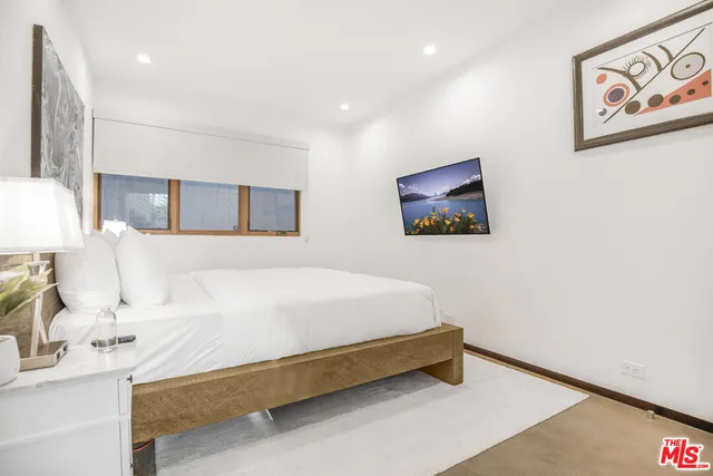 a bedroom with a bed and a lamp