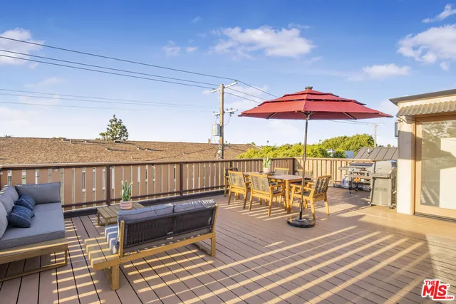 a view of a balcony with wooden floor