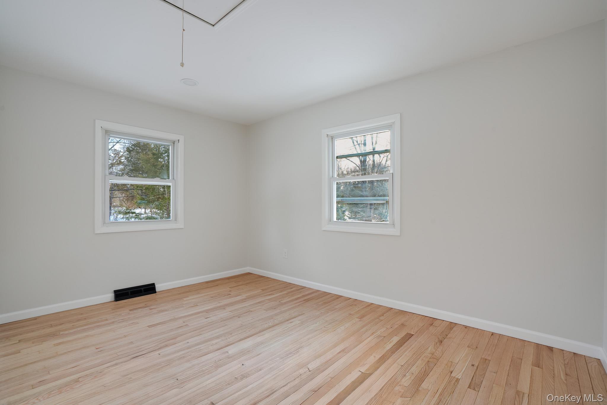 629 Twin Arch Road Rock Tavern, NY 12575 - Photo 12 of 24 wooden floor in an empty room with a window