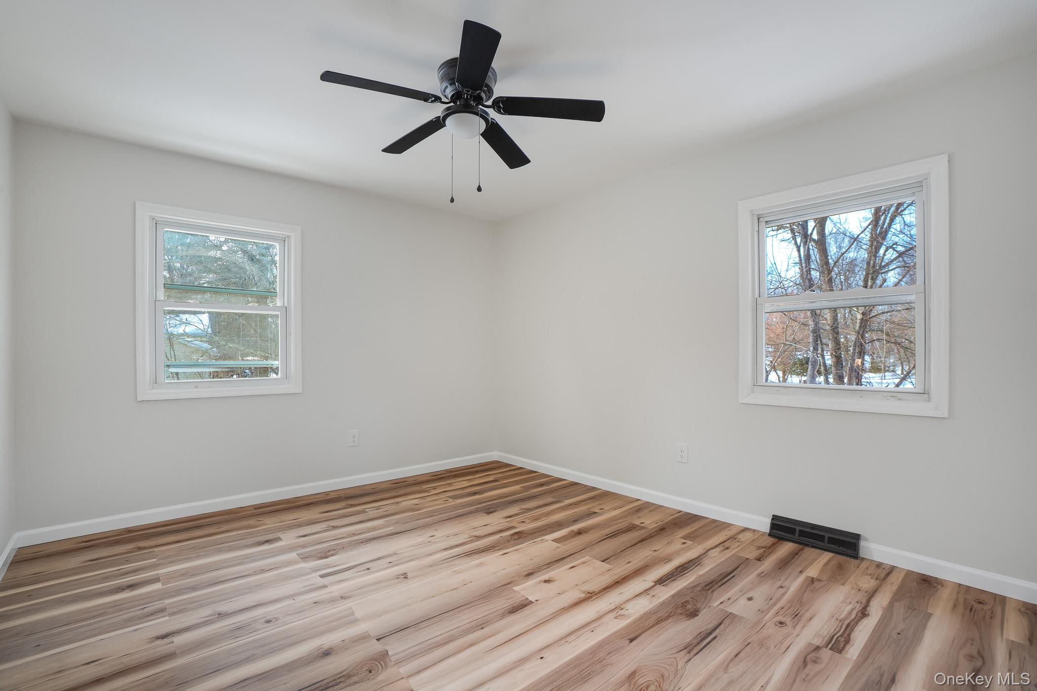 629 Twin Arch Road Rock Tavern, NY 12575 - Photo 14 of 24 a view of empty room with wooden floor and fan