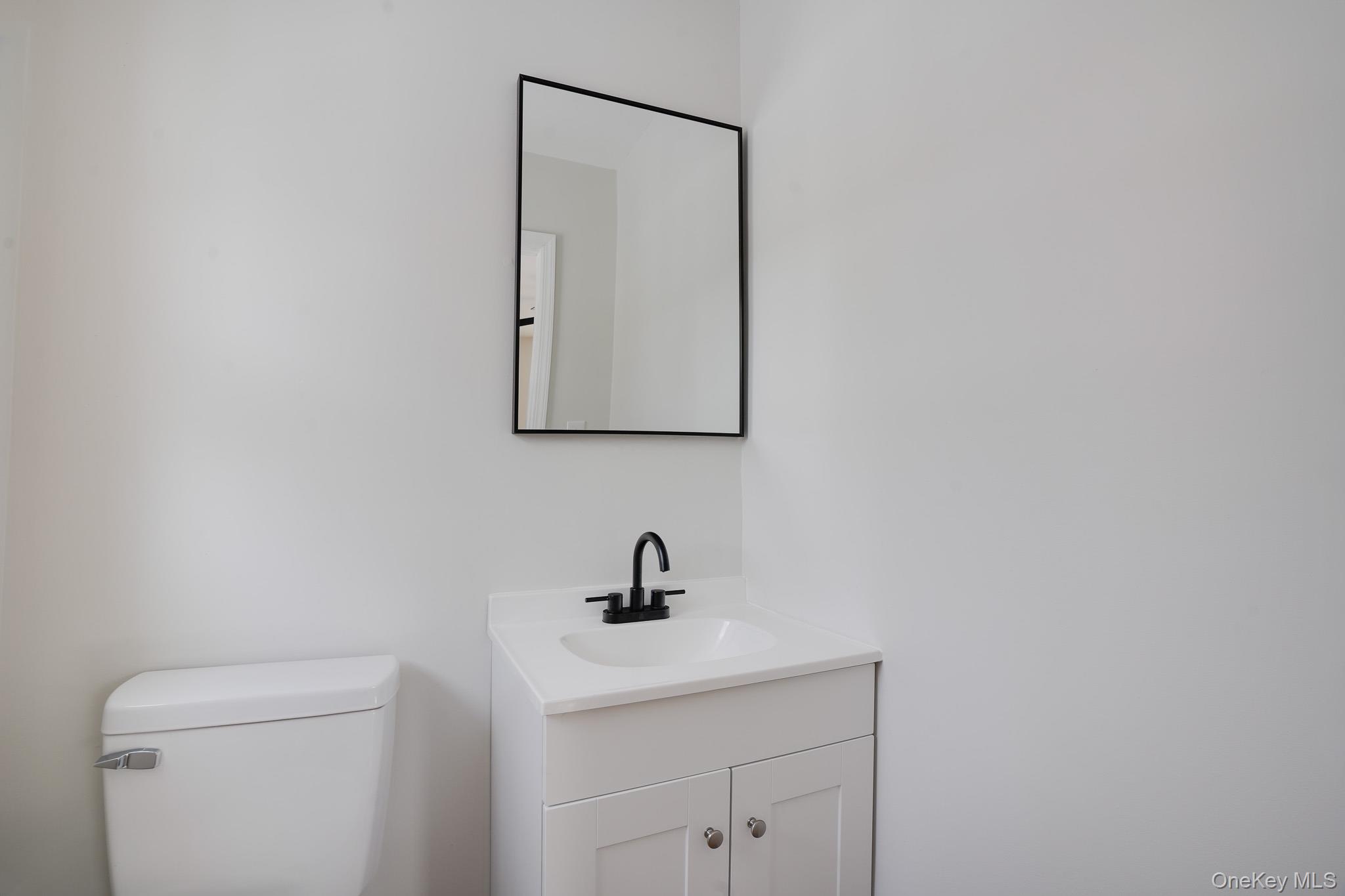 629 Twin Arch Road Rock Tavern, NY 12575 - Photo 16 of 24 a bathroom with a toilet sink and mirror