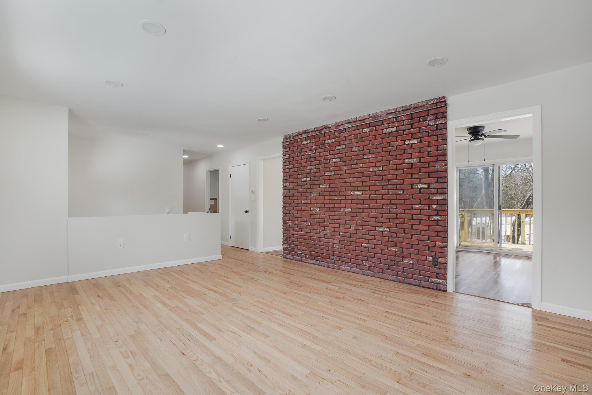 629 Twin Arch Road Rock Tavern, NY 12575 - Photo 3 of 24 a view of an empty room with wooden floor and a window