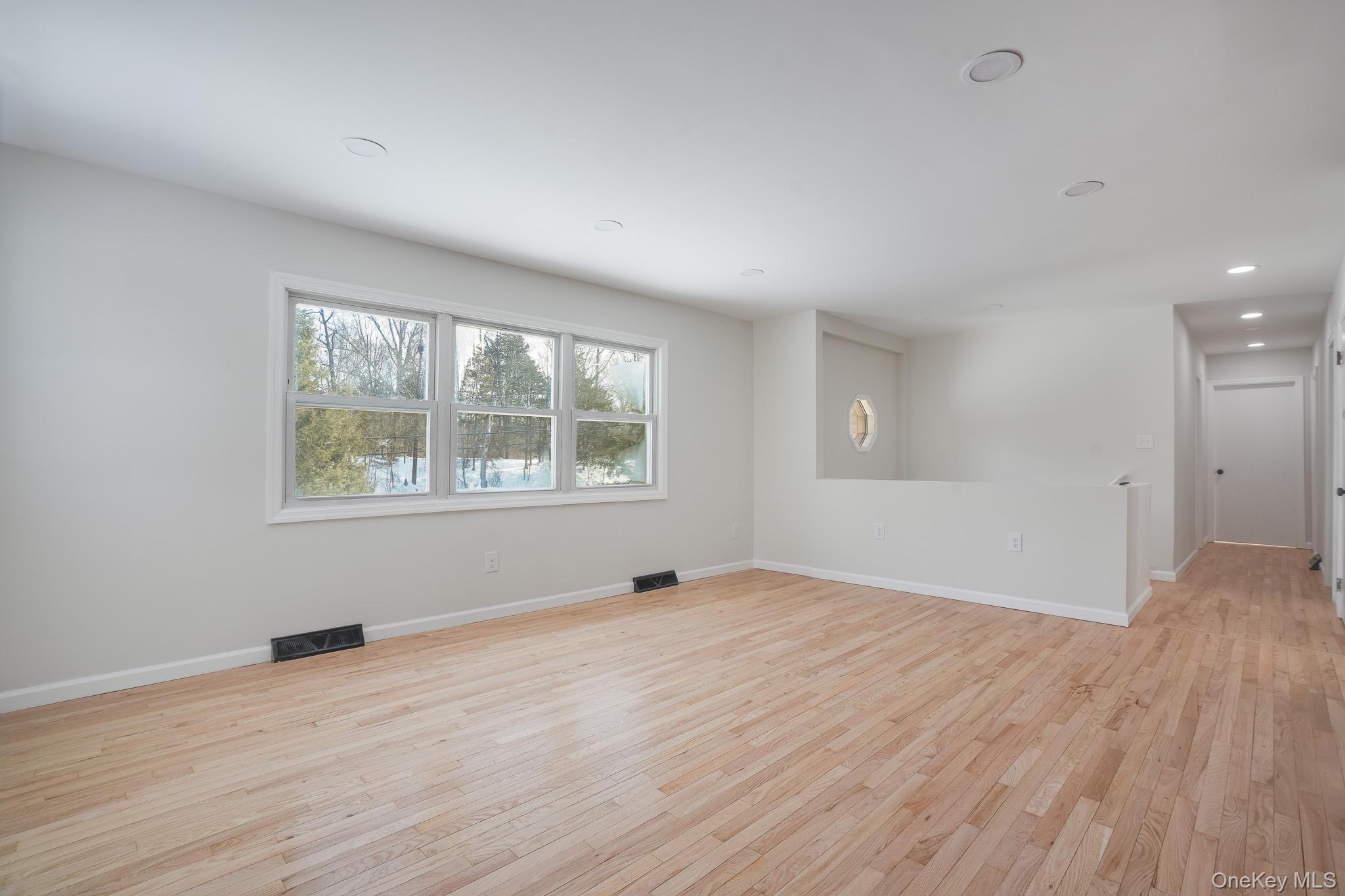 629 Twin Arch Road Rock Tavern, NY 12575 - Photo 4 of 24 wooden floor in an empty room with a window