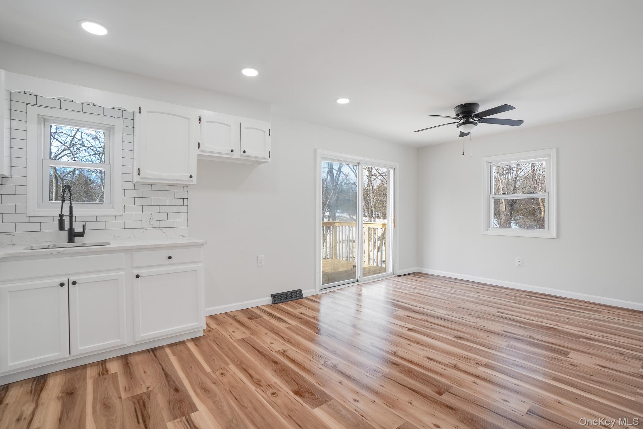 629 Twin Arch Road Rock Tavern, NY 12575 - Photo 5 of 24 a view of a kitchen with wooden floor and a sink