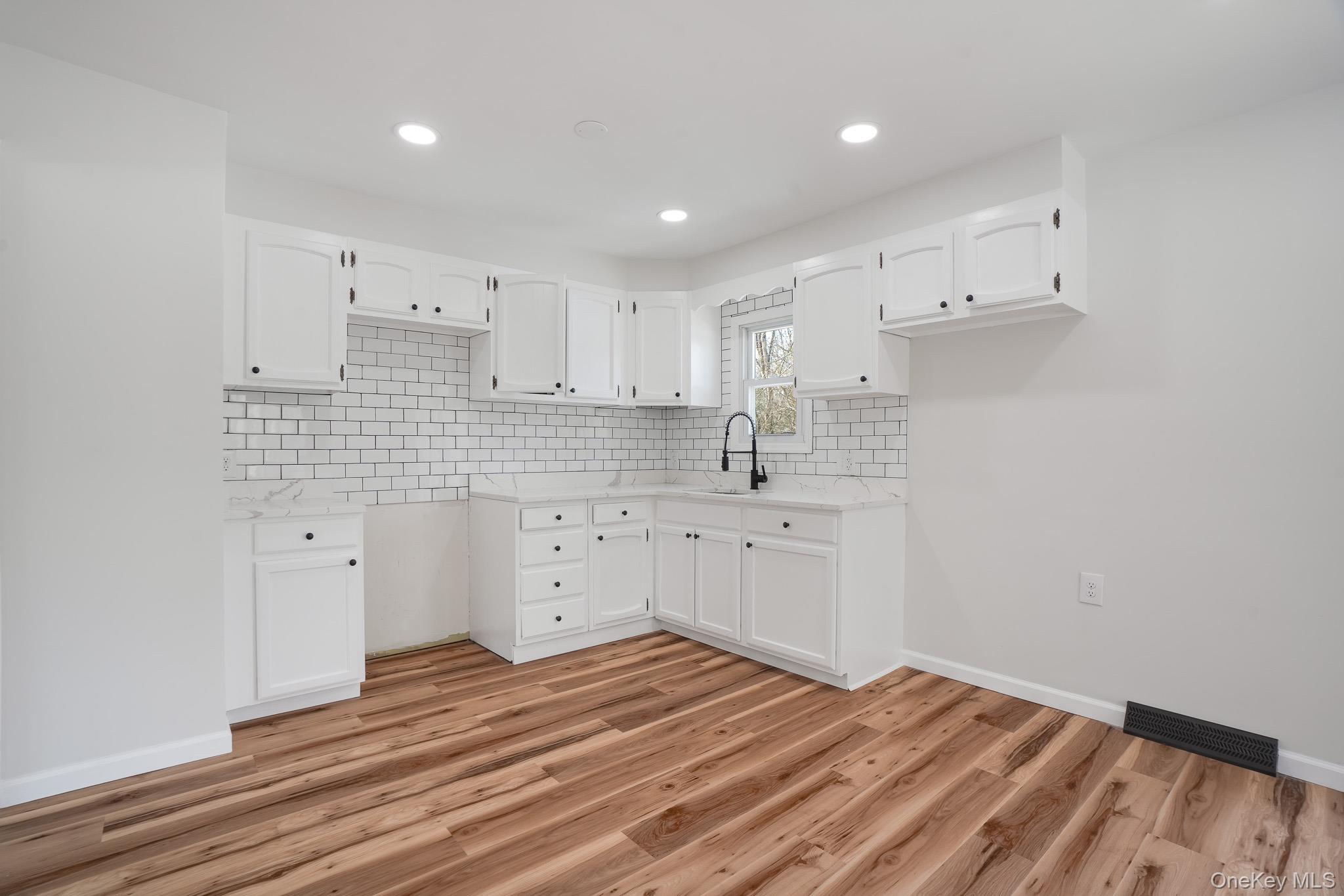 629 Twin Arch Road Rock Tavern, NY 12575 - Photo 8 of 24 a kitchen with white cabinets appliances and a sink