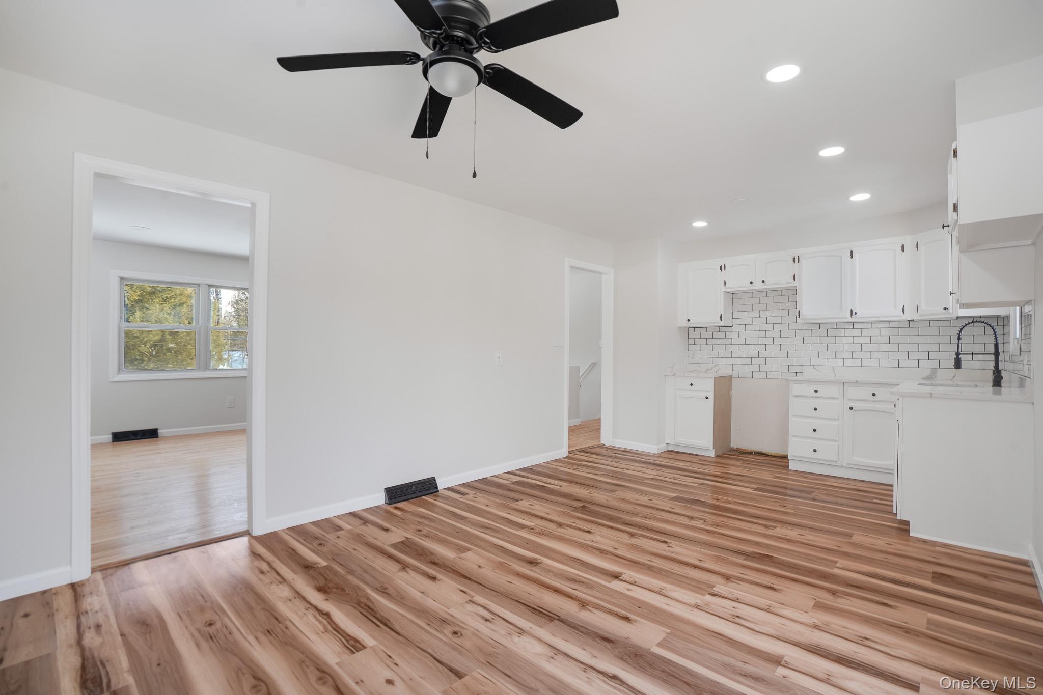 629 Twin Arch Road Rock Tavern, NY 12575 - Photo 9 of 24 a view of a kitchen and empty room with wooden floor