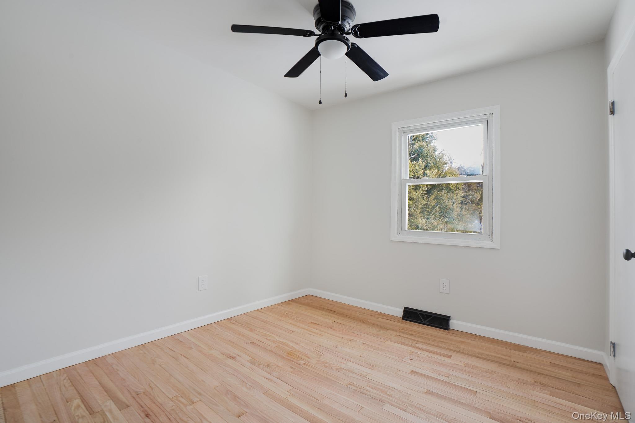 629 Twin Arch Road Rock Tavern, NY 12575 - Photo 10 of 24 a view of empty room with wooden floor and fan