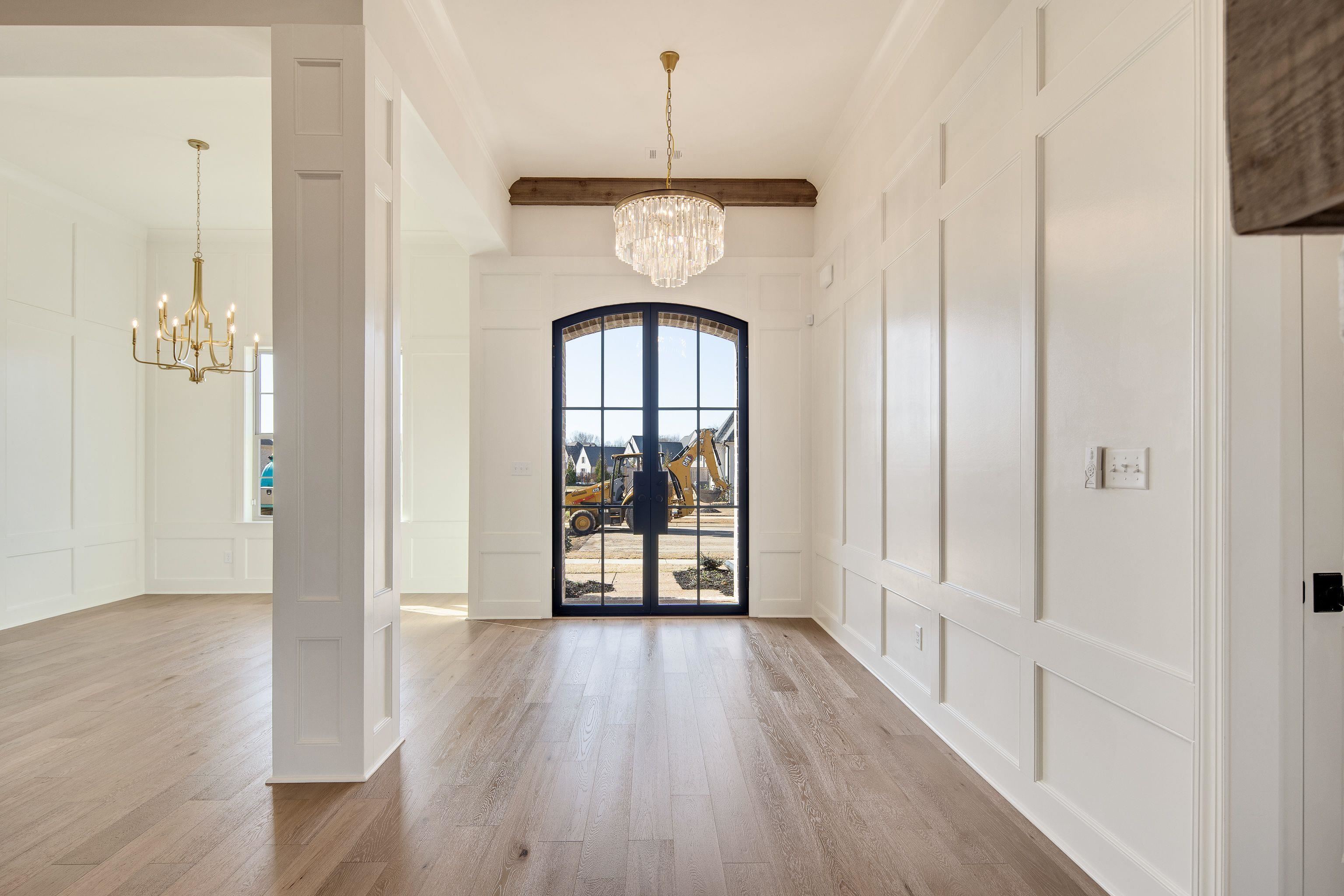 272 Keisie Lane Collierville, TN 38017 - Photo 6 of 30 a view of a hallway with wooden floor and a chandelier