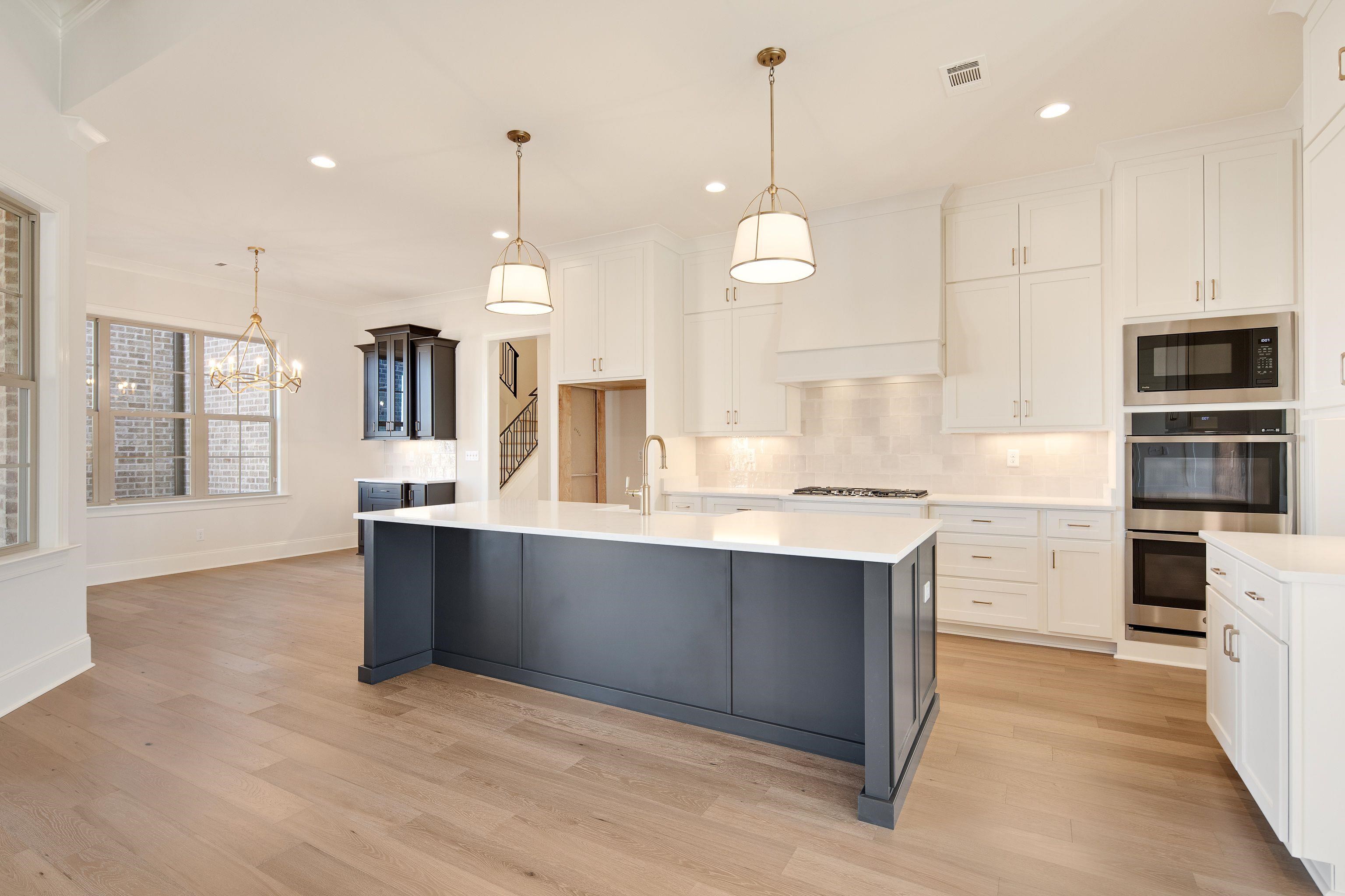 272 Keisie Lane Collierville, TN 38017 - Photo 10 of 30 a large kitchen with granite countertop a large counter top a sink stainless steel appliances and cabinets