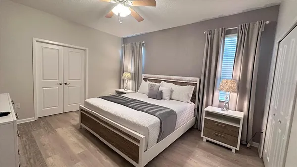a bedroom with a bed and a window