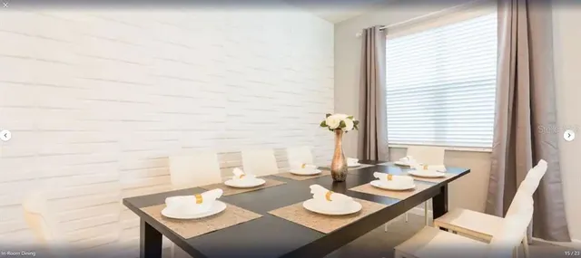 a dining room with furniture and window