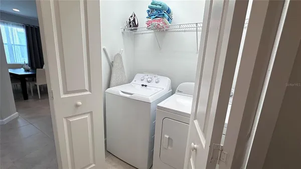 a utility room with a window dryer and washer