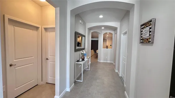a view of a hallway with windows and closet