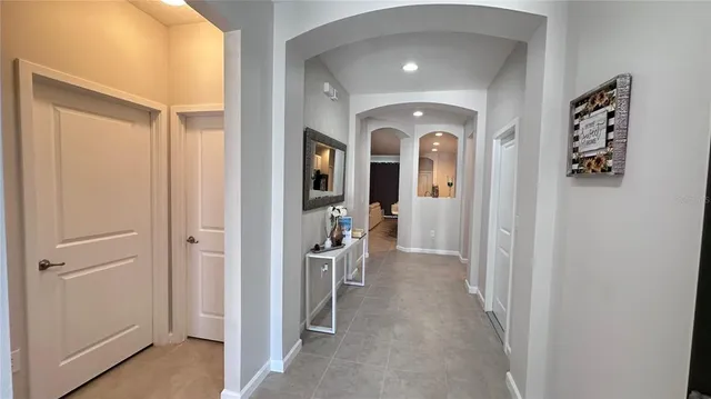 a view of a hallway with windows and closet