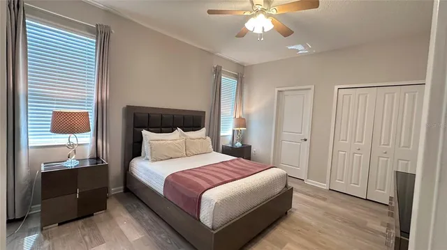 a bedroom with a large bed and a chandelier