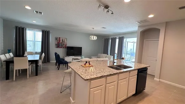 a kitchen with sink and view living room