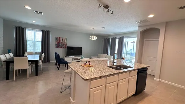 a kitchen with sink and view living room