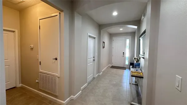 a view of a hallway with wooden shelves