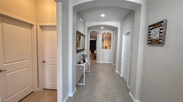 a view of a hallway with a livingroom and a bedroom