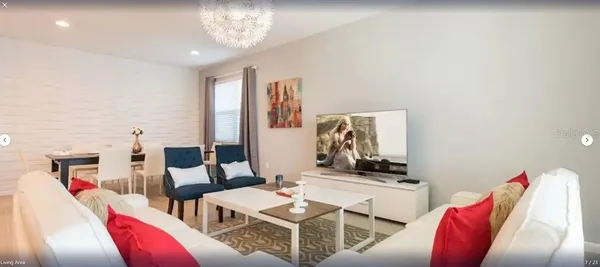 a living room with furniture and a chandelier