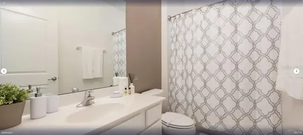 a bathroom with a sink a toilet and shower curtain