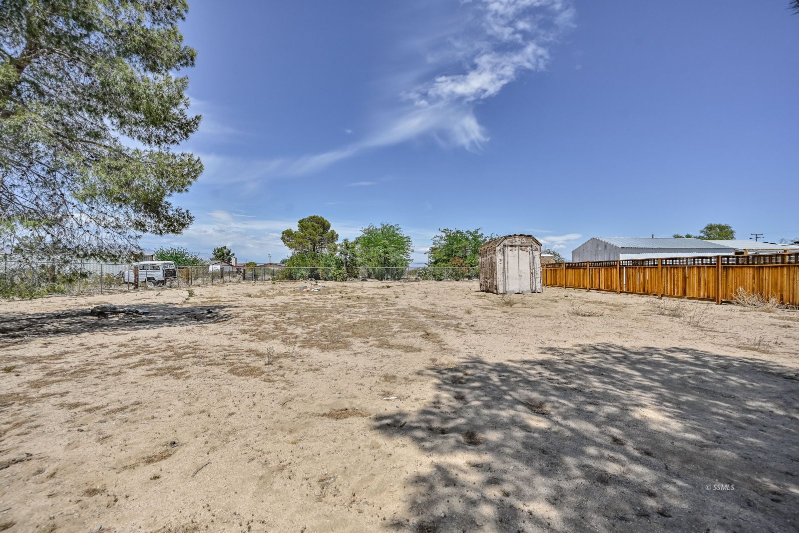 1407 North Indian Wells Street Ridgecrest, CA 93555 - Photo 50 of 50 a view of a dry yard with wooden fence