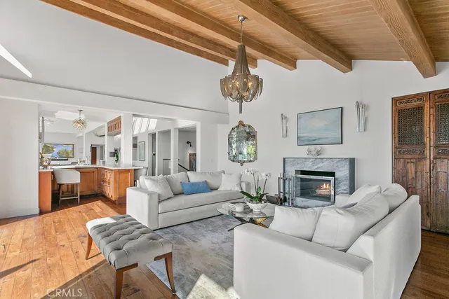 a living room with patio furniture and a chandelier