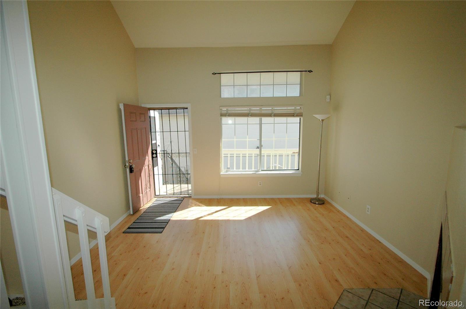 165 South Sable Boulevard, Unit R23 Aurora, CO 80012 - Photo 3 of 11 a view of an empty room with wooden floor and a window
