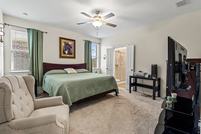 a bedroom with bed a couch and a chandelier