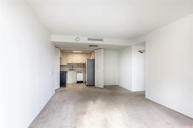 a view of a kitchen with a sink and a refrigerator