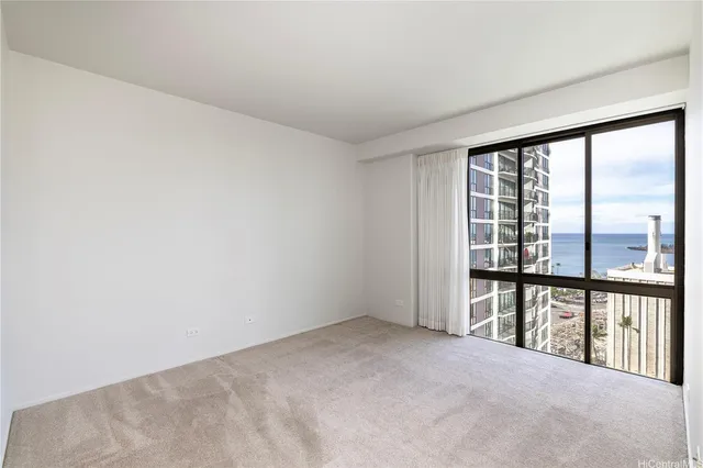 a bedroom with a large bed and a large window