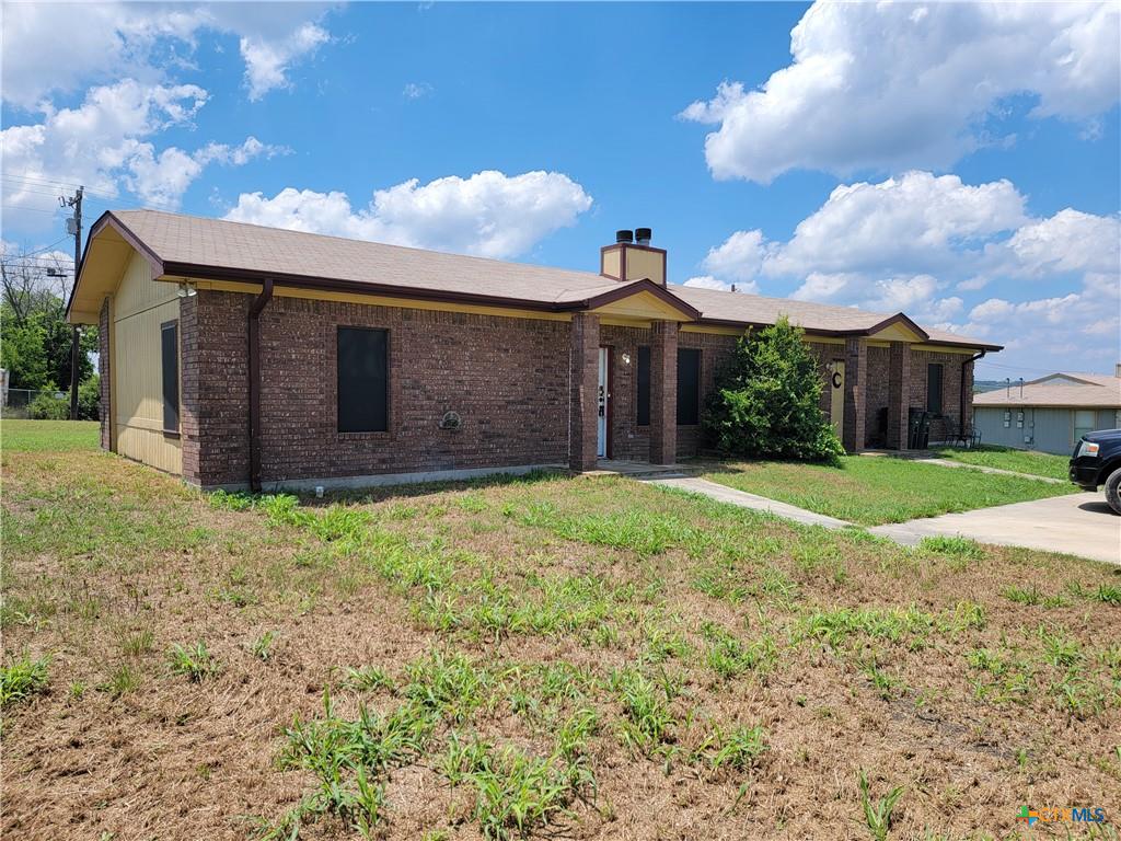 Brick facade with yellow accents creates a welcoming street presence for this multi-unit dwelling.