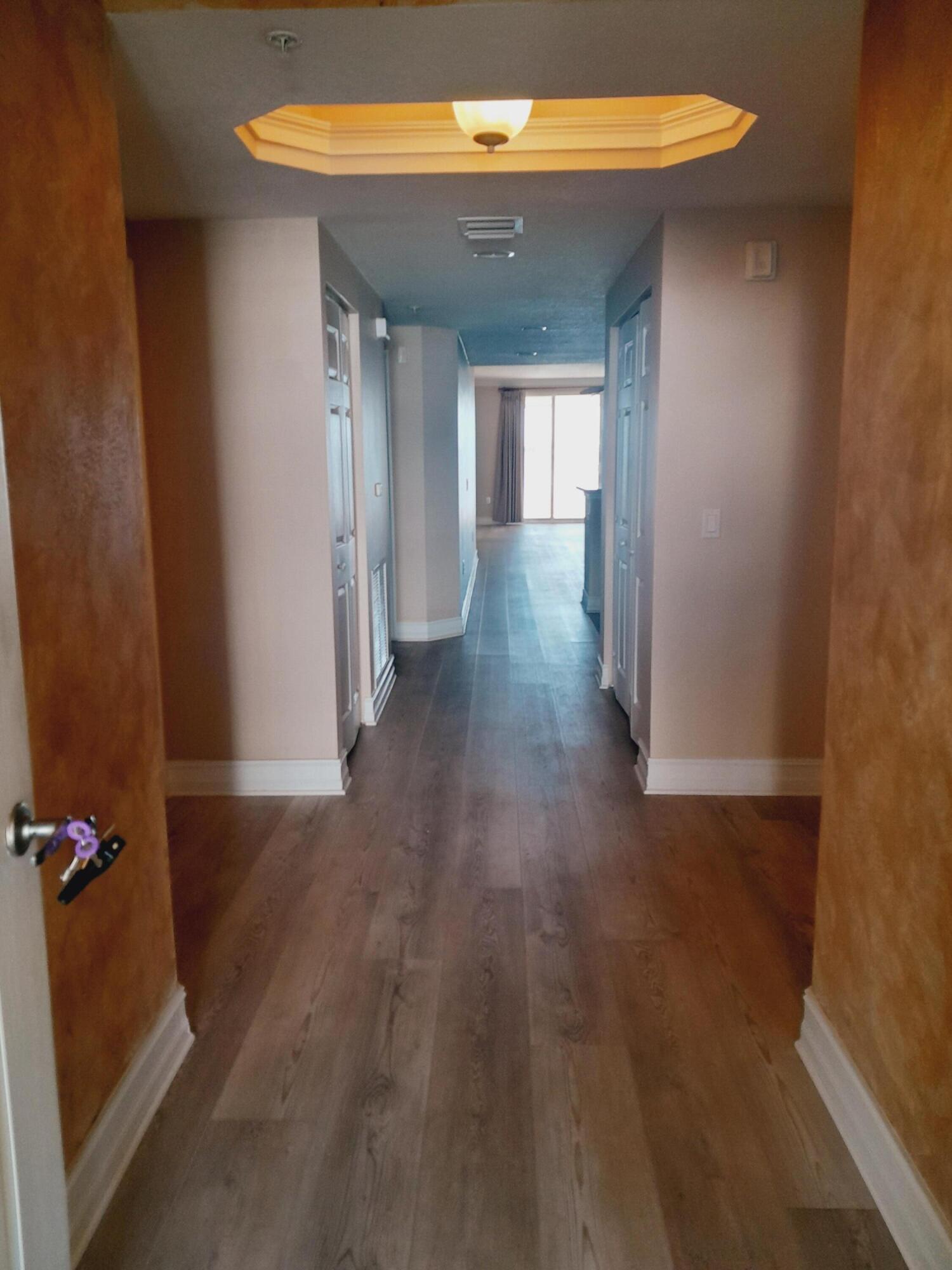480 Sail Lane, Unit 302 Merritt Island, FL 32953 - Photo 3 of 21 a view of a hallway with wooden floor
