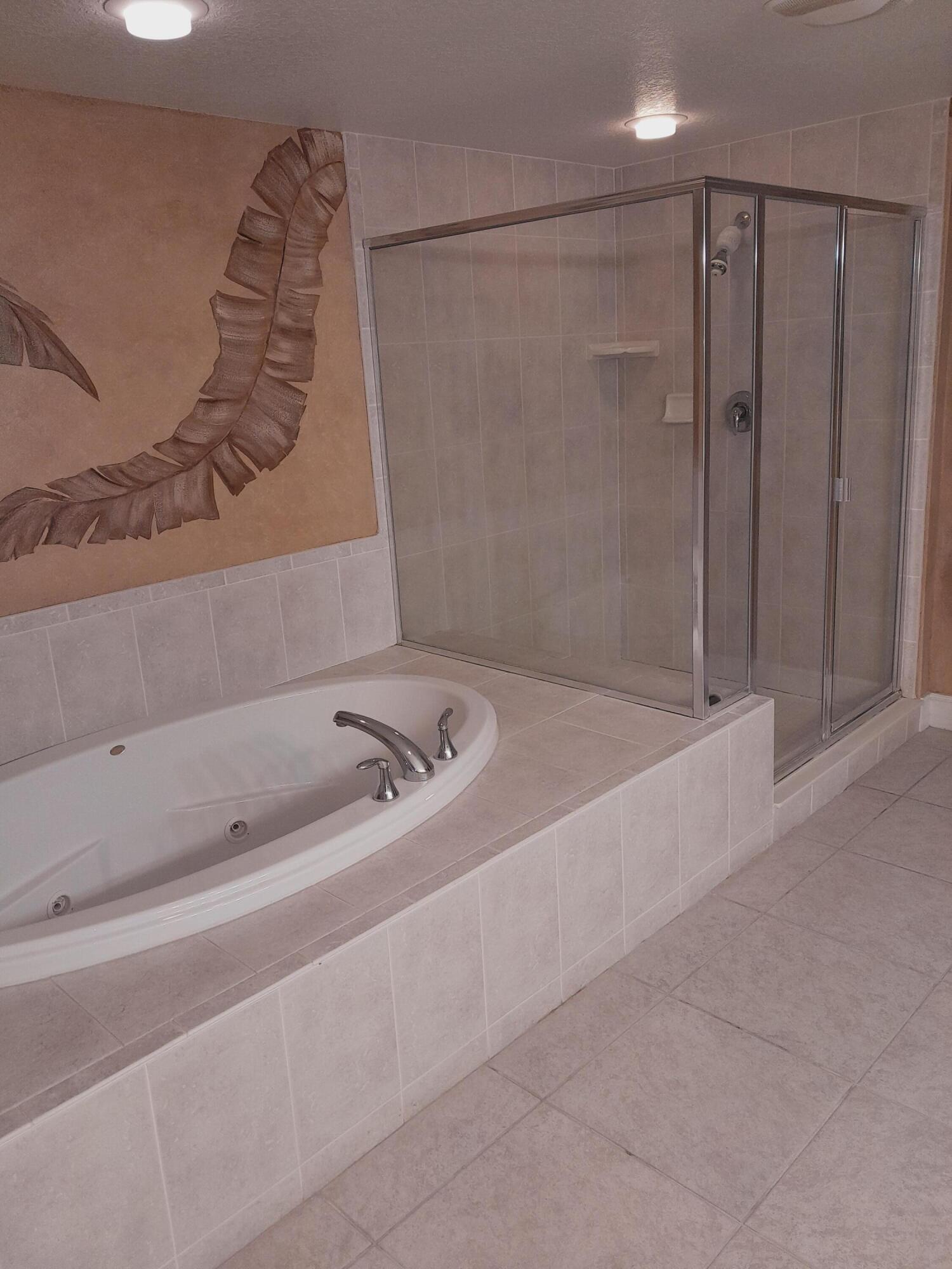 480 Sail Lane, Unit 302 Merritt Island, FL 32953 - Photo 10 of 21 a bathroom with a tub and a shower