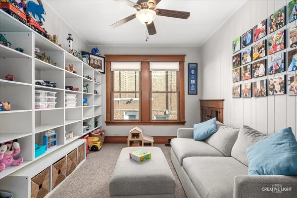 a living room with furniture cabinets and a window
