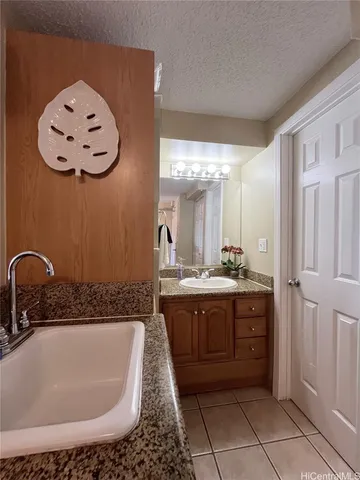a bathroom with a tub sink and mirror