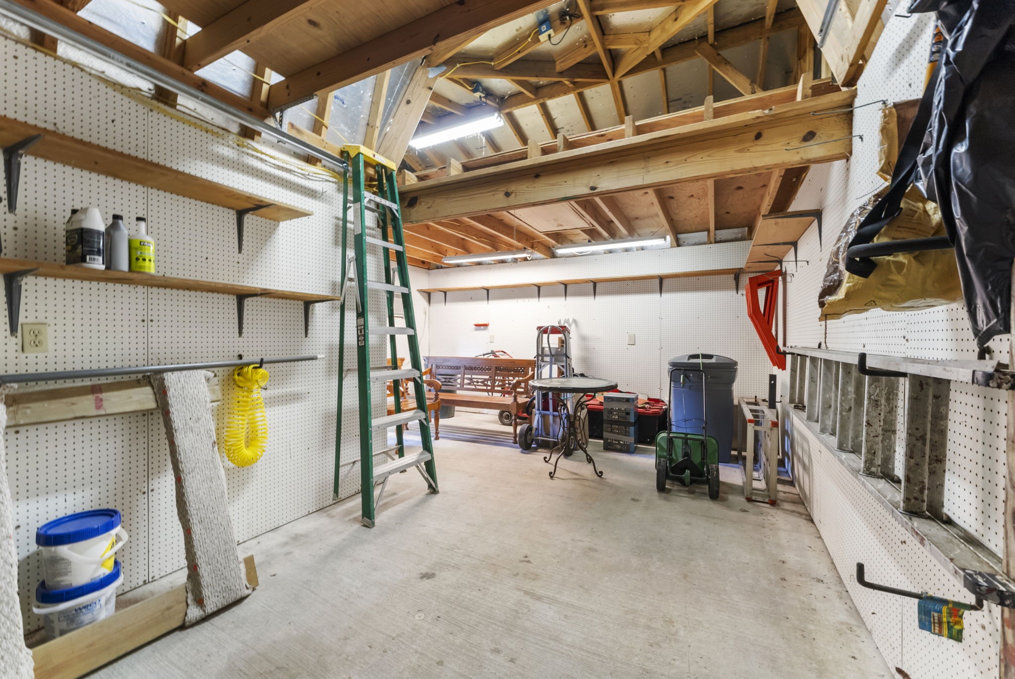24311 Standing Oak Drive Spring, TX 77389 - Photo 41 of 42 This detached workshop is fully powered, offering flexible space for projects, storage, or hobbies. Includes pegboard walls, built-in shelving, and overhead loft storage.