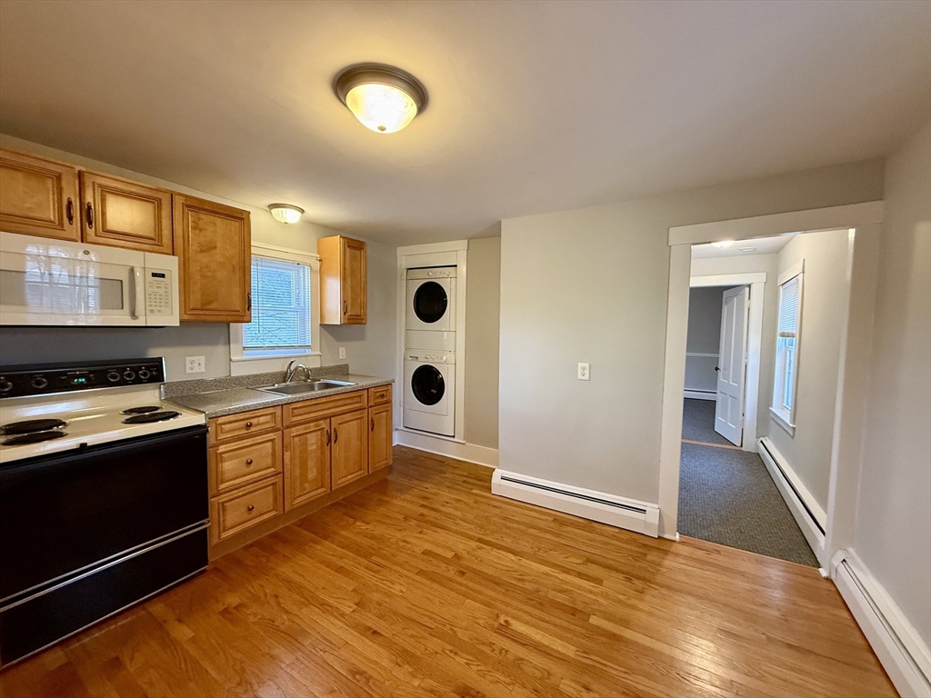 19 Ruggles Street, Unit 2 Westborough, MA 01581 - Photo 3 of 14 a large kitchen with stainless steel appliances granite countertop a stove and a sink