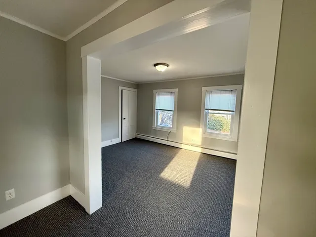 an empty room with windows and closet