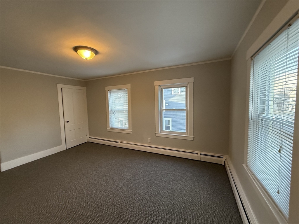 19 Ruggles Street, Unit 2 Westborough, MA 01581 - Photo 9 of 14 an empty room with a empty space and windows