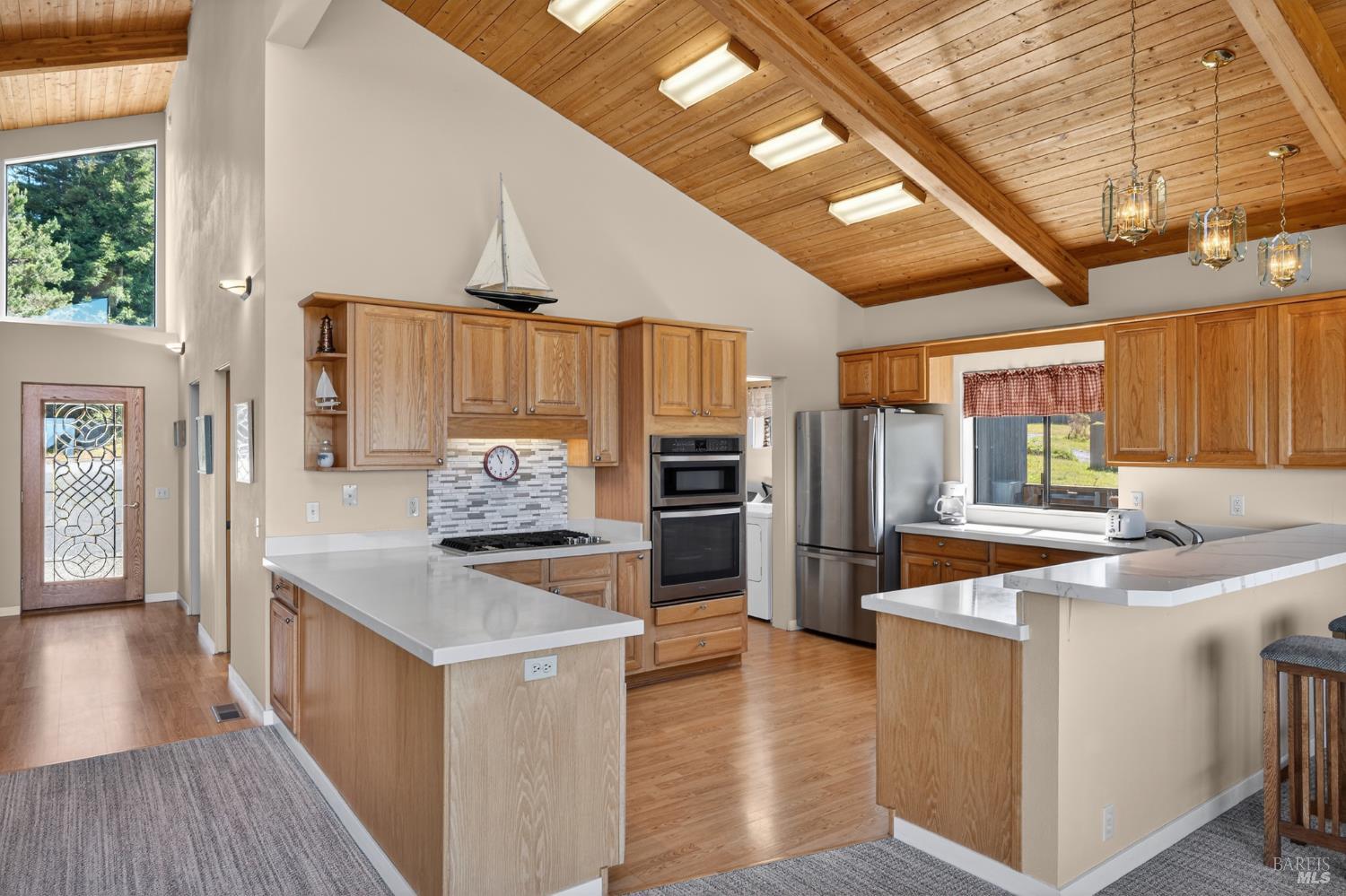 41339 Westwind The Sea Ranch, CA 95497 - Photo 22 of 60 Kitchen with 5 burner cooktop, built in oven and microwave, stainless steel refrigerator and sink with window overlooking patio garden