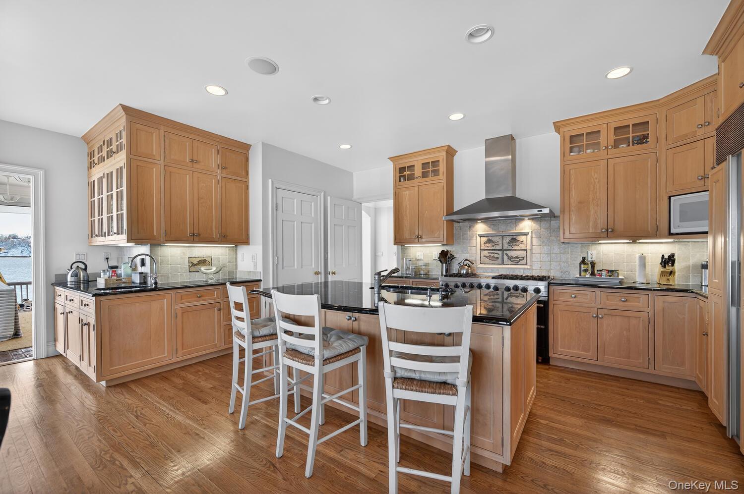 336 Centre Island Road Oyster Bay, NY 11771 - Photo 18 of 38 a kitchen with stainless steel appliances kitchen island granite countertop wooden cabinets and stove top oven