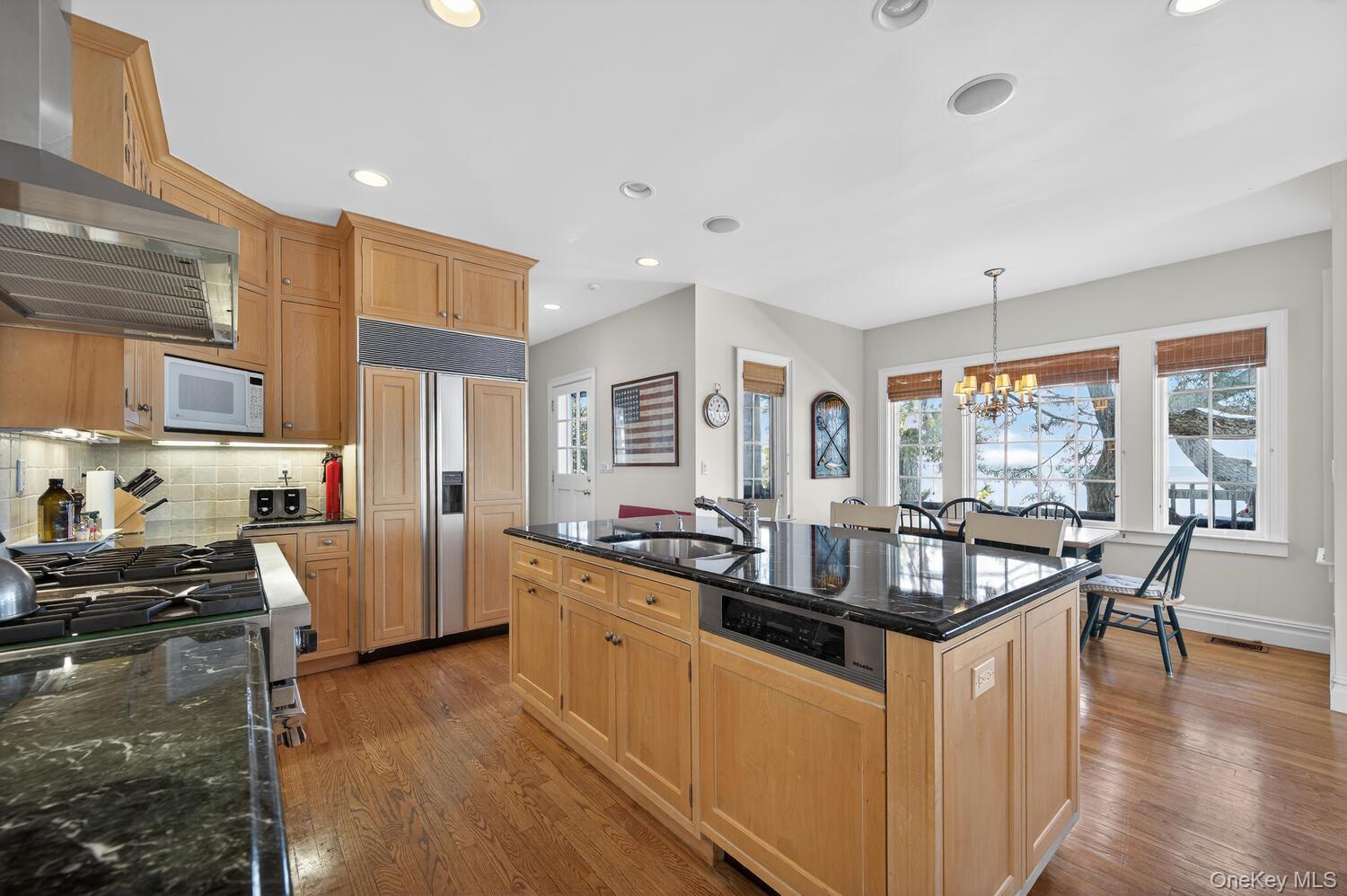 336 Centre Island Road Oyster Bay, NY 11771 - Photo 20 of 38 a kitchen with granite countertop a stove and white cabinets
